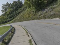 a fire hydrant sitting on the side of a road near grass and trees -