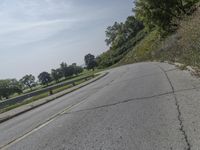 a fire hydrant sitting on the side of a road near grass and trees -