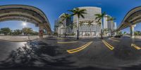 two street intersections with a highway going beneath them on a sunny day in a city