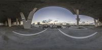 the view of the city from an outdoor park looking down a road in the middle of a circular space