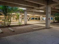 a concrete parking garage with concrete planters and gravel on the ground inside it is shown in image