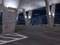 concrete structures and lights against a cloudy night sky with a sky background and a black sky