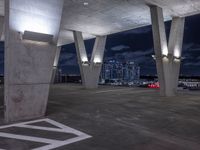 concrete structures and lights against a cloudy night sky with a sky background and a black sky