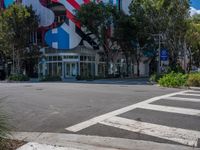 a stop sign and a pedestrian crossing in front of a building with american flag decorations