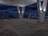 a empty parking garage filled with white lights under some dark clouds at night - time