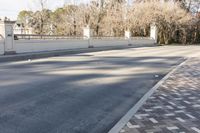 there is an empty paved roadway outside the houses to the street from the curb and sidewalk