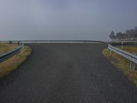 this is an image of a winding highway over the water in foggy weather on a foggy day