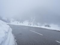 there are a lot of snow on the road thats almost covered in snowballs