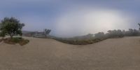 a view of a person riding a skate board with fog covering the air behind them