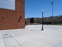 the lights post is along the wall of the building where there are lights on the street