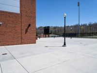 the lights post is along the wall of the building where there are lights on the street