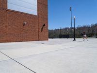 the lights post is along the wall of the building where there are lights on the street