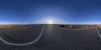 there are cars traveling on the road in this 360 - panoramic view of a distant countryside