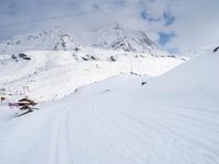 a skier traveling down a slope with a snowboard attached to their legs and head in the air