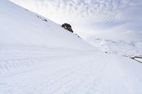 a snow covered mountain with ski tracks leading to it's top slope in winter