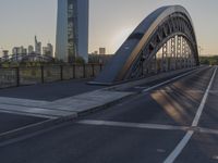 a crosswalk on a bridge that is made out of steel plates and curved beams