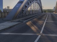 a crosswalk on a bridge that is made out of steel plates and curved beams