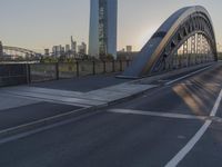 a crosswalk on a bridge that is made out of steel plates and curved beams