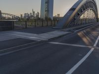 a crosswalk on a bridge that is made out of steel plates and curved beams