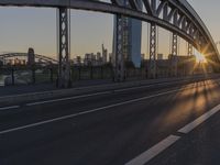 a highway runs next to some tall buildings near the water at sunset and the bridge is under construction