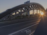 a highway runs next to some tall buildings near the water at sunset and the bridge is under construction