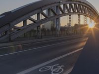 a highway runs next to some tall buildings near the water at sunset and the bridge is under construction