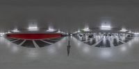 the large terminal has three circular clocks on it's ceiling and a red floor