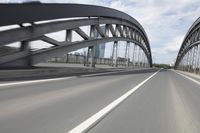 a view from a speeding car looking down the highway toward some buildings on the side of the road