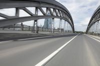 a view from a speeding car looking down the highway toward some buildings on the side of the road
