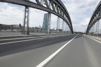 a view from a speeding car looking down the highway toward some buildings on the side of the road