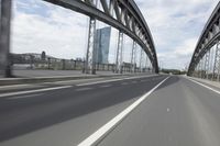 a view from a speeding car looking down the highway toward some buildings on the side of the road