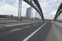 a view from a speeding car looking down the highway toward some buildings on the side of the road