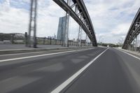 a view from a speeding car looking down the highway toward some buildings on the side of the road