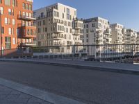 a city side street has no people walking and no cars on it, including one man skateboarding