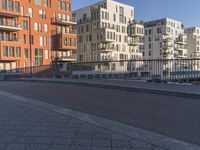 a city side street has no people walking and no cars on it, including one man skateboarding