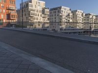 a city side street has no people walking and no cars on it, including one man skateboarding