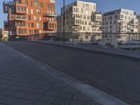 a city side street has no people walking and no cars on it, including one man skateboarding