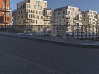 a city side street has no people walking and no cars on it, including one man skateboarding
