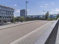 the sidewalk is next to the walkway at the city park in germany looking back at a glassy office