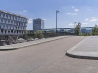 the sidewalk is next to the walkway at the city park in germany looking back at a glassy office