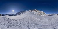 there is a camera that is using a fisheye lens to view the snow covered mountain