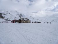 a group of people are skiing down the slope on a sunny day at a resort