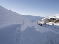 a mountain side with several skis sitting on top of snow covered slope next to mountains