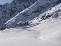 a snow boarder is riding down the snowy slopes of a mountain side mountain in winter