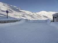 some snow mountains and no cars on it in the snow at the top of a hill