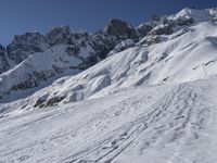 a skier is leaving the trail as it makes its way uphill in the snow