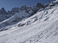 a skier is leaving the trail as it makes its way uphill in the snow