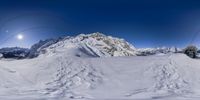 an aerial view of some skiiers in the snow at the bottom of the mountains