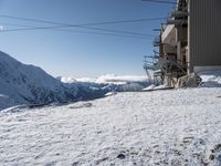 a large snowy slope with some skis and snow covered slopes in the background on a clear day