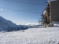 a large snowy slope with some skis and snow covered slopes in the background on a clear day